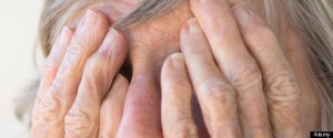 arthritic wrinkled hands of old woman hiding face